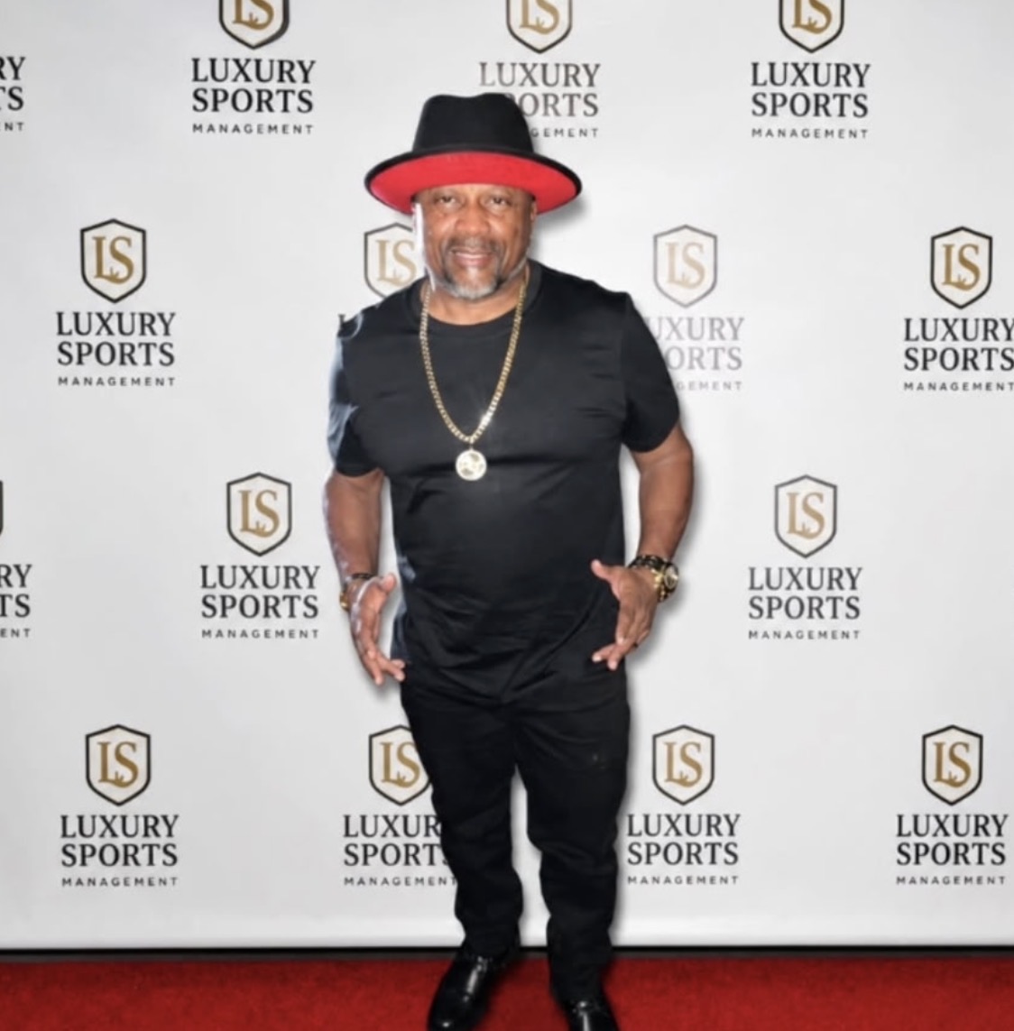 Lamont Hewitt on the Luxury Sports Management red carpet step-and-repeat
